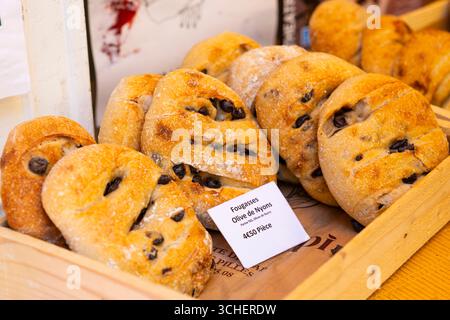 Köstliches Fougasse-Brot mit Oliven, frisch gebacken und in einer Holzkiste auf einem Markt in Nyons, Frankreich, präsentiert Stockfoto