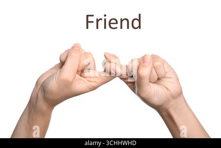 Frau zeigt Wort Freund auf weißem Hintergrund, Nahaufnahme. Gebärdensprache Stockfoto