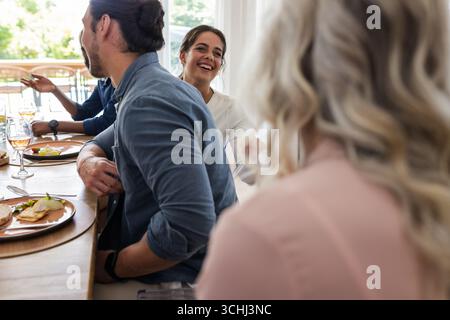 Lachen und Spaß haben, Freunde am Hochzeitsempfang im Gespräch Stockfoto