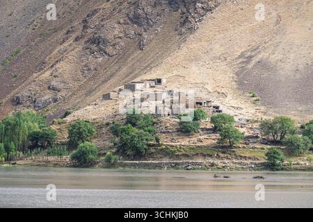 Malerischer Blick auf die Berglandschaft des abgelegenen afghanischen Dorfes o im Tal des Panj Flusses, gesehen von Rushan, Gorno-Badakhshan, Tadschikistan Pamir Stockfoto