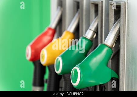 Nahaufnahme von vier Kraftstoffdosierdüsen an einer Gaspumpe, bereit zum Betanken. Eine detaillierte Ansicht der modernen Tankstellenausstattung. Stockfoto