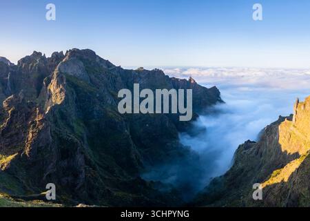 Blick aus der Vogelperspektive auf die Berge und Wanderwege, die während eines Sonnenuntergangs im Frühling zum Pico Pico do Arieiro führen. Insel Madeira, Portugal. Stockfoto