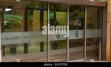 LUXEMBURG, EUROPA - 1. SEPTEMBER 2025 - Glastüren der Chambre des Deputes spiegeln umliegende Gebäude und Bäume in Luxemburg-Stadt wider Stockfoto