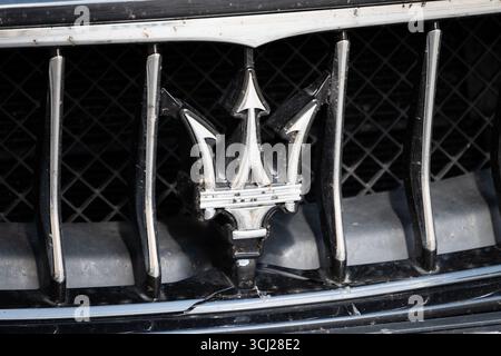Maserati Trident Logo-Zeichen des italienischen Luxuswagenherstellers. Nahaufnahme des Emblems im Kühlergrill. Tote Insekten kleben drauf. Stockfoto