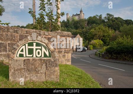 Alton Village Schild, Alton Castle aus dem 19. Jahrhundert auf dem Hügel, Churnet Valley, Stoke on Trent, Staffordshire, England Stockfoto