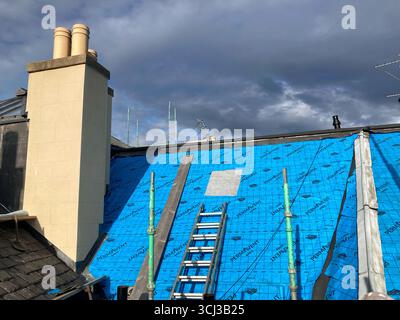 Das kommunale Dach repariert derzeit ein Gebäude in Edinburgh, installiert eine atmungsaktive wasserdichte Membranunterlage und erneuert die Sättigungsarbeiten Stockfoto