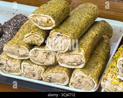 Grüne Pistazien türkischer Genuss gefüllt mit Sahne und Nüssen in einem Süßwarengeschäft. Süße, Tradition und Gourmet-Genuss Stockfoto