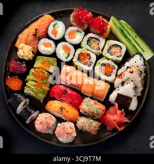 Verschiedene Sushi-Nigiri und Maki-großes Set. Eine Auswahl an japanischem Sushi mit Thunfisch, Krabben, Lachs und Brötchen auf dunklem Hintergrund. Draufsicht Stockfoto