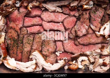 Gebackenes und in Scheiben geschnittenes Schweinefleisch, Rind- und Lammfleisch, Blick von oben. Fleischhintergrund. Stockfoto