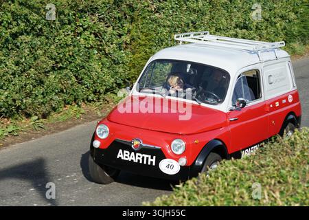 Klassisches Retro Red Abarth Auto, das auf einer Landstraße fährt. Shere Hill Climb, East Clandon, Guildford Stockfoto