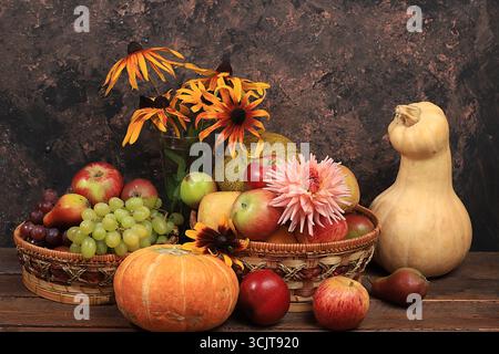 Herbsthintergrund mit saisonaler Natur Herbstbeeren, Kürbisse, Äpfel, Trauben, Melonen und Blumen auf altem Hintergrund, Kopierraum, Happy Thanksgiving Stockfoto