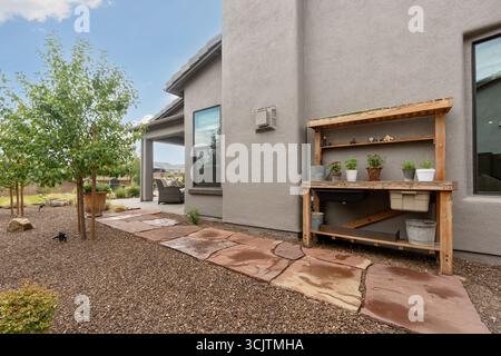 Davor befindet sich ein Haus mit einer Holzwerkbank Stockfoto