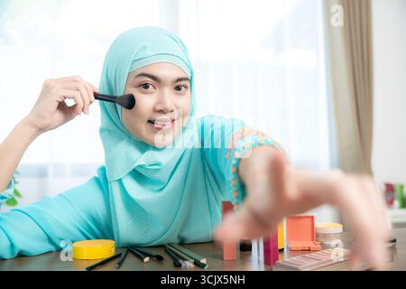 Beauty Vlogger Streaming Live Make-up Tutorial, in dem Kosmetikanwendungen für Online-Publikum demonstriert werden. Konzept digitaler Karriere und moderner Lebensstil Stockfoto