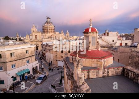 Skyline von Rabat mit der St. Paul Kirche Kuppel auf der linken Seite bei Sonnenuntergang, Rabat Mdina, Malta Stockfoto