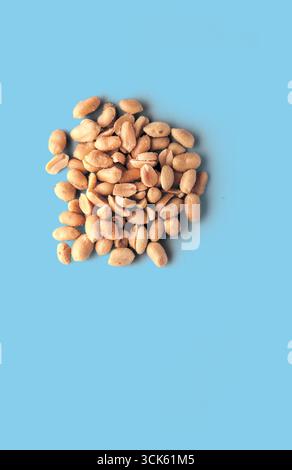 Ein Haufen von Erdnüssen, die auf einer Oberfläche angeordnet sind und ihre natürliche Textur und Farbe zeigen. Stockfoto