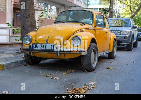 Gelber Retro-VW-Käfer, klassischer VW-Käfer auf einer Stadtstraße, Oldtimer mit modernem Twist Stockfoto