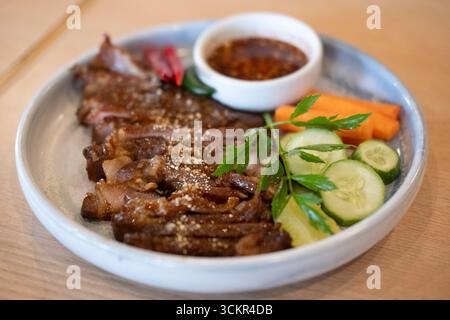 Gegrillter Schweinehals, serviert auf Teller Stockfoto