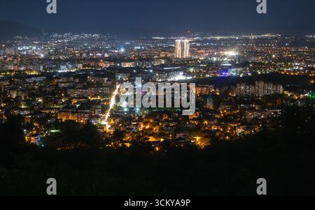 Atemberaubende nächtliche Stadtlandschaft mit leuchtenden Lichtern, die die Skyline der Stadt beleuchten, von einem hohen Aussichtspunkt aus aufgenommen Stockfoto