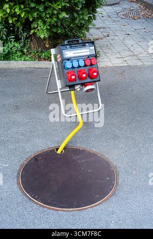 Spiez, Schweiz - 11. September 2025: Ein tragbares Stromverteilergerät auf einem Ständer mit Kabeln. Stockfoto