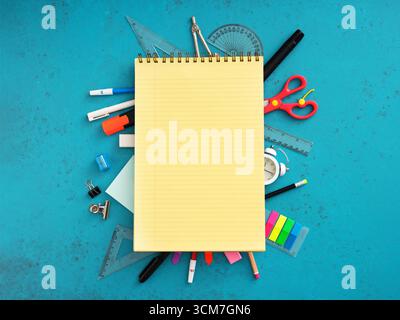 Schulmaterial, das einen leeren Notizblock auf blauem Hintergrund umrahmt und so ein lebendiges Schulkonzept schafft Stockfoto