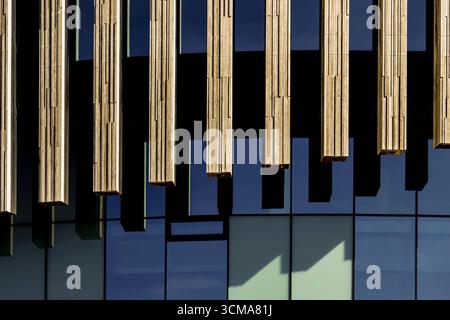 Rhythmische Reflexionen: Modernes Nordisches Design. Die Royal Arena in Kopenhagen, Dänemark, wurde von 3XN und HKS zusammen mit den Ingenieuren Arup und ME Engineers entworfen und verfügt über eine Fassade aus vertikalen Holzlatten, die gegen reflektierende Glaspaneele angeordnet sind, die Funktionalität mit ästhetischem Charme im Stadtteil Orestad South verbinden. Stockfoto