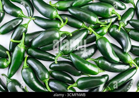 Ein Haufen grüner mexikanischer Jalapeno-scharfer Paprika aus nächster Nähe. Draufsicht. Lebensmittelfotografie Stockfoto