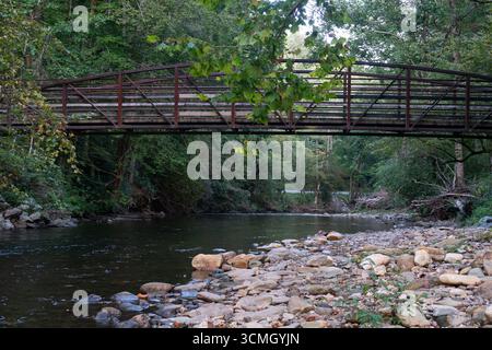 Eine Fußgängerbrücke überquert den Davidson River im Pisgah National Forest in North Carolina. Stockfoto