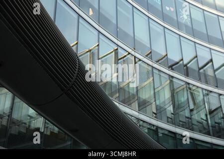 Kreatives Warschauer Bürogebäude mit geschwungenen Metallic-Details und geometrischem Glasmuster Stockfoto