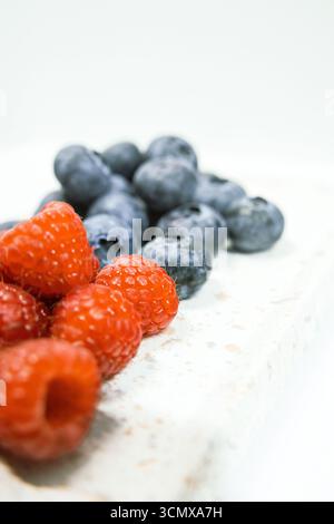 Raspberries and blueberries are a healthy colorful nutritious breakfast or dessert. A closeup shot that show the juicy details. Perfect for a wallpape Stockfoto