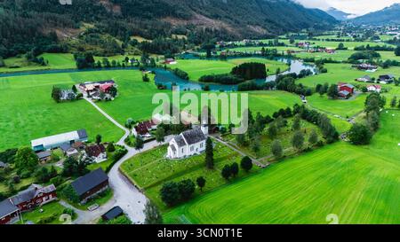 Ein atemberaubender Blick aus der Vogelperspektive zeigt die grüne Landschaft von Stryns und zeigt die wunderschönen Felder, gewundenen Flüsse und die bezaubernde Architektur inmitten der natürlichen Schönheit während eines ruhigen Tages. Stockfoto