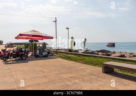09.09.2025 - Batumi, Georgia - Elektroroller zum Mieten am Strand Stockfoto