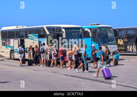 Parikia, Paros, GR - 22. August 2025: Reisende steigen am Terminal in Paros, Griechenland, in einen KTEL-Bus ein Stockfoto