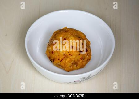 Köstlicher Aloo Bharta auf einer weißen Schüssel. Es ist traditionelles bengalisches (Bangladeshi) Essen. Es ist bekannt für seine Einfachheit und seinen geschmackvollen Geschmack. Stockfoto