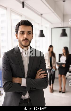 Selbstbewusster junger Profi aus dem Nahen Osten, der für Porträt steht Stockfoto