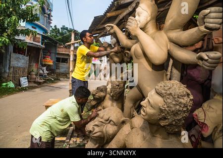 Handwerker arbeiten an den letzten Schliffen, malen Ton-Idole der Hindu-Göttin Durga in einer Werkstatt in der Töpferkolonie zu Zeiten von Mahalaya, einer der wichtigsten Regionen im Bezirk Nadia, aus dem die größte Anzahl von Ton-Idolen produziert werden, vor dem Durga Puja Festival in Tehatta, Westbengalen. Auf Mahalaya zeigt das Ritual von Chokkhu Daan (Augenspenden) Götzenmacher die Augen der Göttin Durga, eine heilige Handlung, die das Götzenbild zum Leben erweckt und das spirituelle Erwachen der göttlichen Form markiert. (Foto: Soumyabrata Roy/Pacific Press) Stockfoto