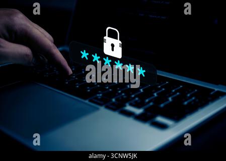 Benutzerauthentifizierung Nahaufnahme einer Hand, die ein verstecktes Passwort auf einem Laptop eingibt, wobei digitale Sicherheit, Datenschutz, sichere Daten und passw hervorgehoben werden Stockfoto