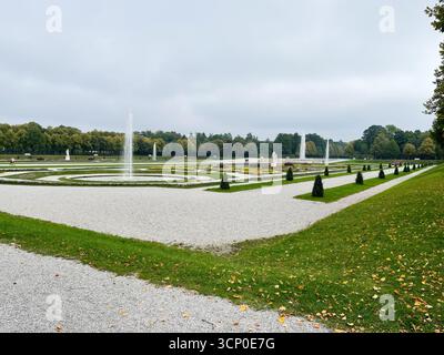Oberschleissheim, Deutschland - 25. September 2022: Ein ruhiger formeller Garten Schloss Schleissheim in Deutschland mit runden Parterres, Springbrunnen, Statuen und Stockfoto