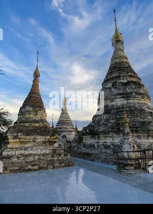 Abendstrahlen mit blauem bewölktem Himmel über buddhistischen Stupas in Bagan in Myanmar Stockfoto
