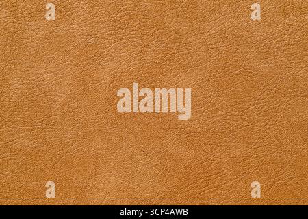 Eine braune Lederoberfläche mit einer genarbten Textur. Die Oberfläche ist leicht erhöht und fühlt sich leicht rauh an Stockfoto