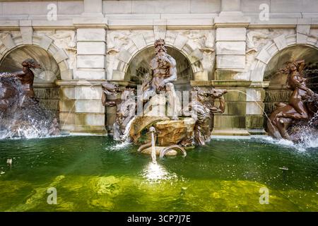 Court of Neptune Fountain Library of Congress Washington DC // WASHINGTON DC — die Bronzeskulpturen des Court of Neptune Fountain, die sich an der Vorderseite des Library of Congress Thomas Jefferson Building befinden, wurden 2017 vom Architect of the Capitol aufbewahrt. Der Brunnen zeigt Neptun, den König des Meeres, seine Söhne, die Tritons, die Muscheln blasen, Nymphen und Wassertiere, alles in heldenhafter Größe. Der Bildhauer Roland Hinton Perry entwarf den Brunnen, der vom Trevi-Brunnen aus dem 18. Jahrhundert in Rom inspiriert und 1898 fertiggestellt wurde. Die Grottenelemente, einschließlich Delfine und St. Stockfoto