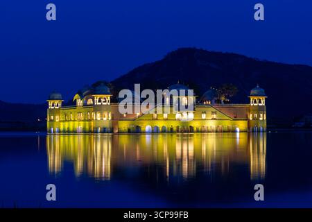 Der legendäre JAL Mahal beleuchtet bei Nacht mit Reflexion auf dem Dunklen See Stockfoto