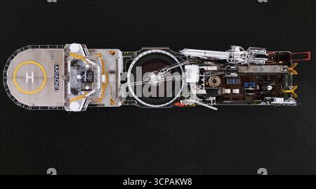 Nyack, USA - 16. September 2025: Luftaufnahme eines großen Schiffes mit Hubschrauberlandeplatz und komplexer Maschine, die eine starke Figur im Dunkeln schneidet Stockfoto