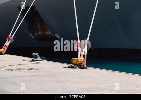 Festmachen eines Schiffes im Hafen mit Festmacherleinen an einem Schiffspoller am Kai Stockfoto