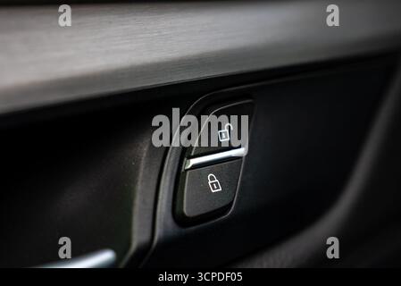 Nahaufnahme der Verriegelungs- und Entriegelungstasten der Innenverkleidung des BMW X6 Stockfoto