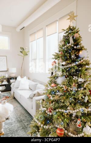 Gemütliches Wohnzimmer mit wunderschön dekoriertem weihnachtsbaum Stockfoto