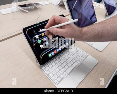 Posen, Polen – 20. September 2025: Nahaufnahme einer Hand, die mit einem Apple Pencil auf einem Apple iPad-Bildschirm navigiert und die vielseitigen kreativen Capabili hervorhebt Stockfoto