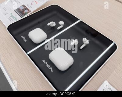 Poznan, Polen – 20. September 2025: AirPods und AirPods Pro schnurlose Ohrstöpsel und Hüllen auf einem dunklen Display, die moderne Audioinnovation betonen Stockfoto