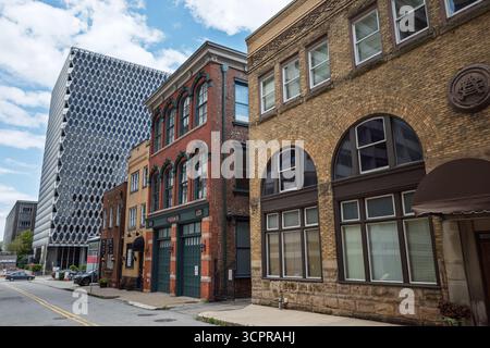 Ein beeindruckender Kontrast zwischen alter und neuer Architektur mit historischen Backsteinhäusern neben dem zeitgenössischen Hochhaus PPG Place in Pittsburgh. Stockfoto