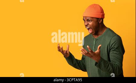 Porträt Eines Wütenden Afroamerikanischen Mannes, Der Mit Wut Auf Gelbem Hintergrund Schreit Stockfoto