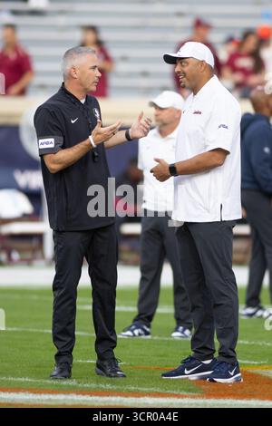 Charlottesville, VA, USA. September 2025. Mike Norvell, Cheftrainer der Florida State Seminoles, spricht mit Tony Elliott, dem Trainer der Virginia Cavaliers, vor dem NCAA-Fußballspiel zwischen den Florida State Seminoles und den Virginia Cavaliers im Scott Stadium in Charlottesville, VA. Jonathan Huff/CSM/Alamy Live News Stockfoto